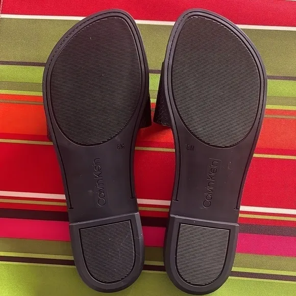 Brand New Calvin Klein Black Large Strap Sandals Flats w/ Gold Tone Metal Logo