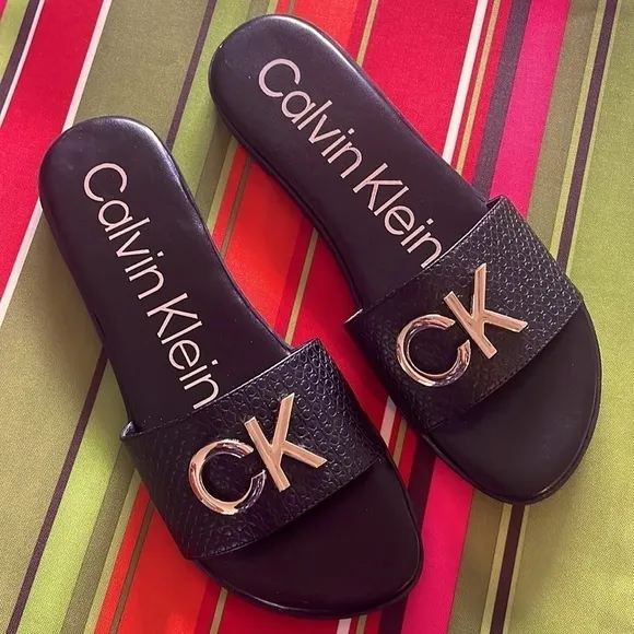 Brand New Calvin Klein Black Large Strap Sandals Flats w/ Gold Tone Metal Logo