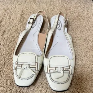 Tod's SZ 10, made in Italy smooth white flats with back ankle strap.
